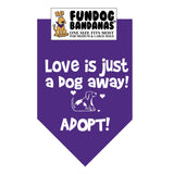 Purple one size fits most dog bandana with Love is Just a Dog Away Adopt and a dog in white ink.